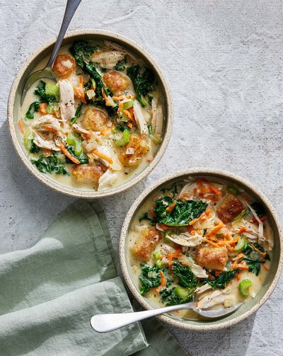 An overhead shot of creamy soups filled with vegetables.