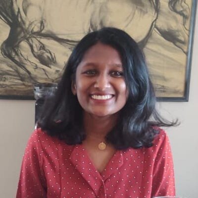 Upasana has dark hair and is smiling