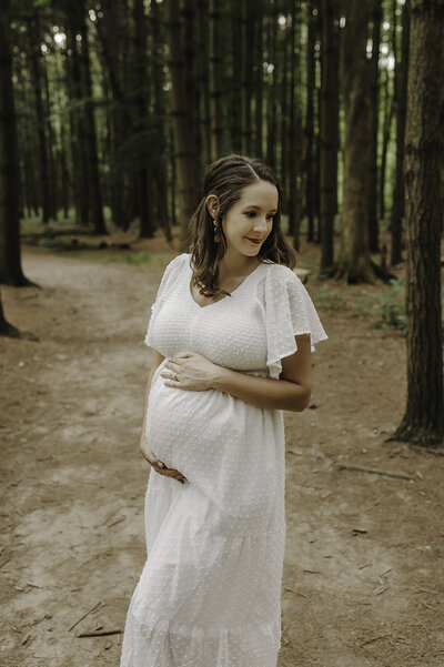 Verona B Photography captures a gorgeous maternity picture of a mom holding her belly at Silver Creek metro Park in Norton, OH. You could see the mom’s love on her face for her unborn baby setting in this serene forest-vibe setting near Akron, OH.