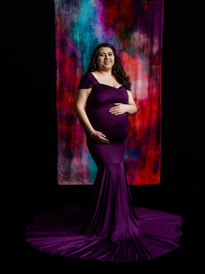 Pregnant woman in purple dress during studio session with Melissa Byrne Prescott, Arizona Photographer