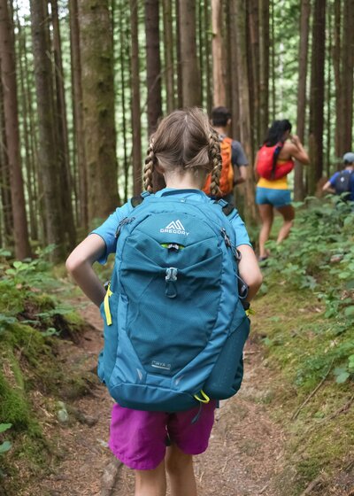 Picture of a girl hiking a mountain trail with friends and family
