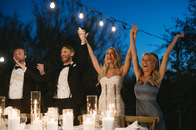 Bride and groom holding hands with guests at wedding reception at El Chorro in Paradise Valley, Arizona