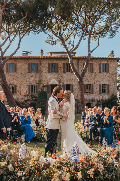 bride and groom embrace on tropical beach