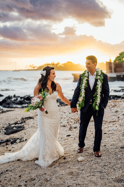Couple Walking at sunset during their Big Island weddings