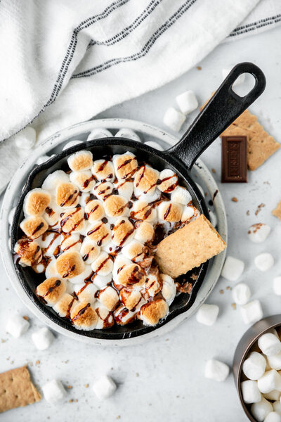 marshmallows, chocolate, and graham crackers in a skillet