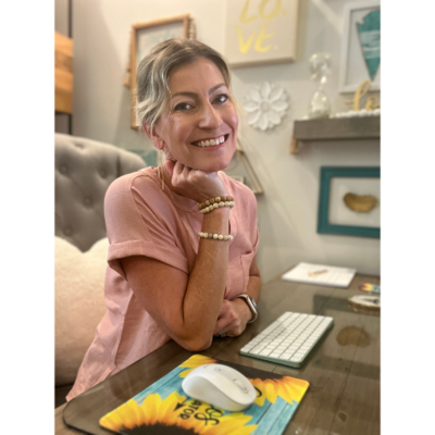Jill smiling while sitting at her desk