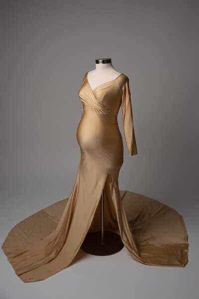 Metallic gold vneck gown with high slit, styled for studio maternity portraits