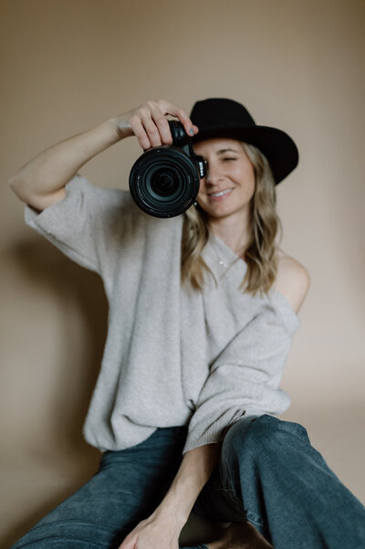 Portrait of Mandy posing with her camera
