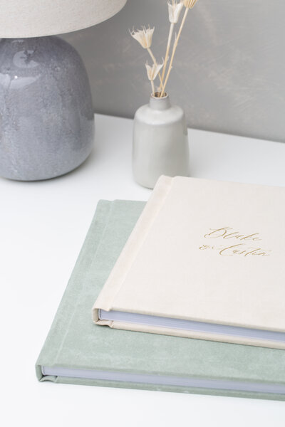 photo albums on nightstand sage green suede and cream linen