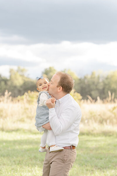 dad kisses daughter during Manassas, Virginia family picture
