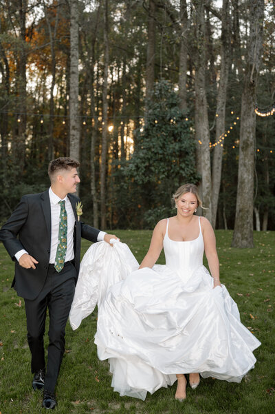 Walking with her back against the, a bride is about the walk down the aisle of a magical outdoor venue that looks like it is from a fairytale.