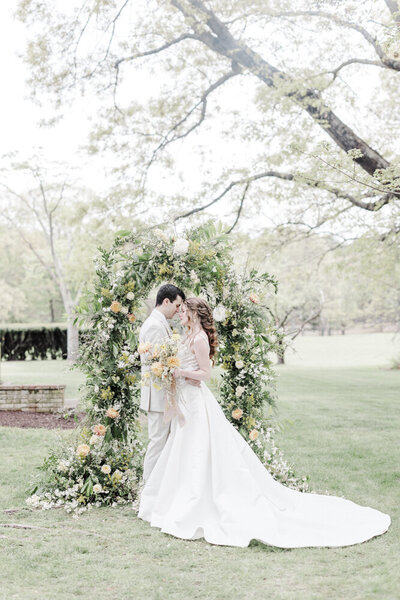 groom holding bride as she twirls her dress