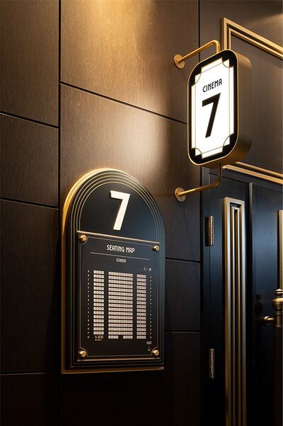 Elegant and clean upscale cinema design of theater doors in gold and black