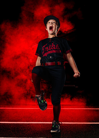 a travel baseball player yells in a dramatic sports photo