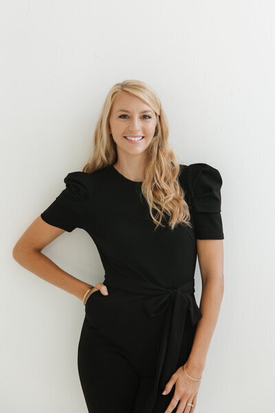 St. Louis wedding planner Allyssa wearing black dress smiling at camera