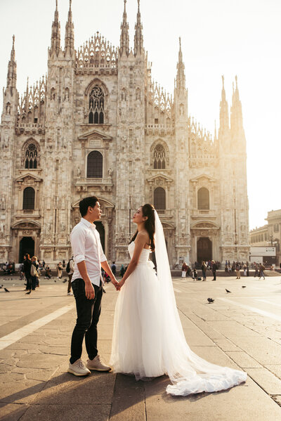 The bride and groom celebrate their wedding against the backdrop of a breathtaking sunset in Milan, creating a warm and enchanting atmosphere as they embark on their journey together