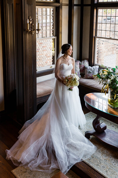 Bride poses for portrait holding bouquet