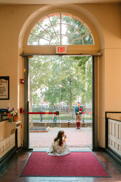 Flower girl looking out window