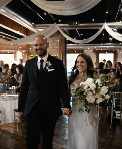 bride and groom entering wedding reception