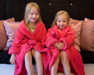 Two girls sitting in robes waiting to get their nails done by one of the Feel Fabulous nail techinicians.