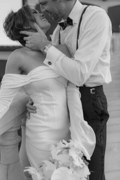 couple holding hands by the water