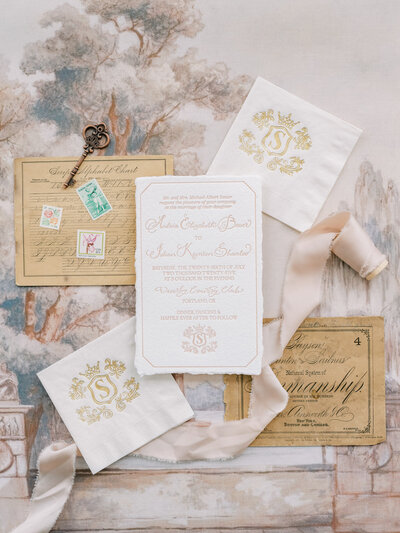 Luxury wedding invitation featuring calligraphy, wedding monogram on napkins and styled with ribbon representing full service design and calligraphy by Life in Letters.