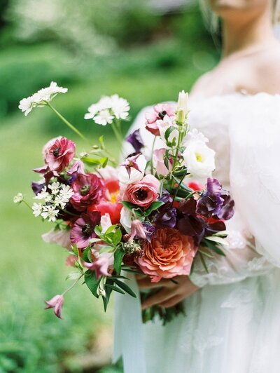 An asheville wedding photographer captures a close up of a bride resting on her groom's shoulder