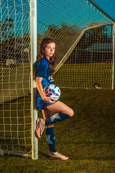 Soccer player posing with ball