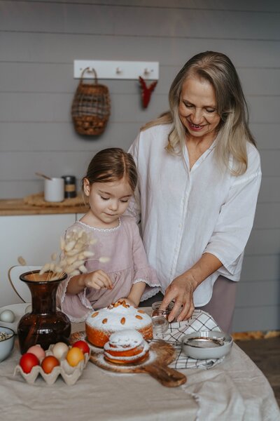 Woman and granddaughter making a cake.