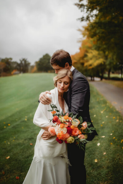 Newlyweds embrace for Newlywed Portraits on their Micro Wedding Day in Asheville, NC.