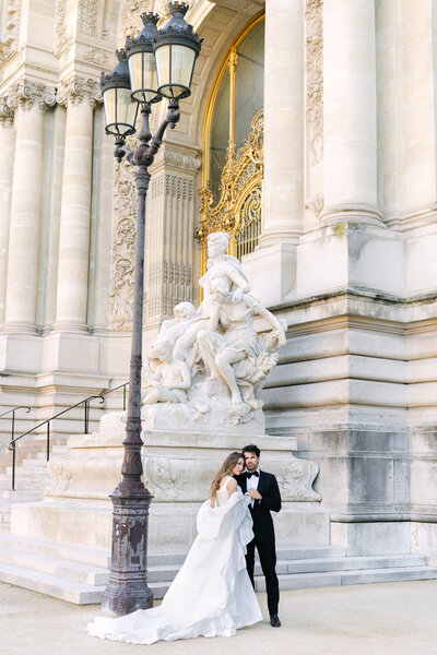 Paris elopement portraits of bride and groom in front of golden doors at Petit Palais