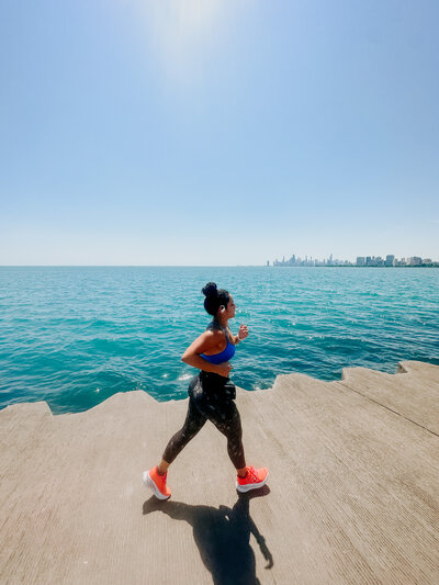 Teresa running along the lake