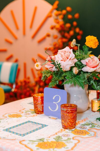Disco balls sitting next to each other with flowers sticking up from them.