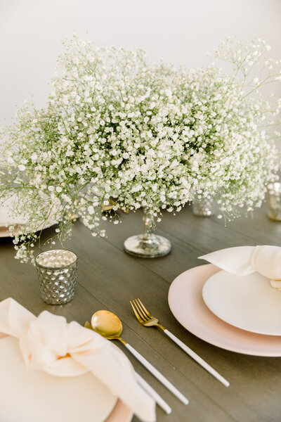 Modern tall centerpiece with baby's breath and phalaenopsis orchids