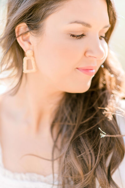 Mother looks over and down her left shoulder for close up portrait by Morgan Leigh Photography.