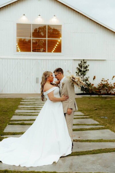 stunning bridal portraits at arkansas venue with bride and groom looking at each other