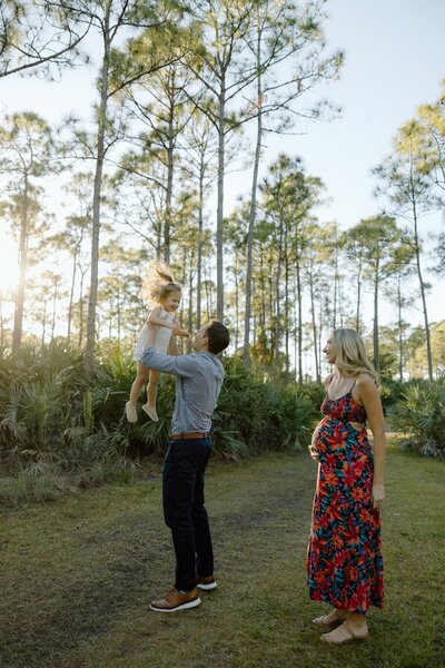 couple plays with their daughter during photo session in south florida