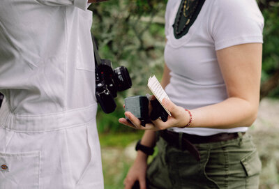 Cinematic wide shot of the couple embracing on the summit, with soft focus and natural light.
