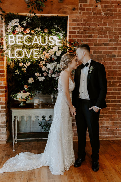 couple standing by neon sign