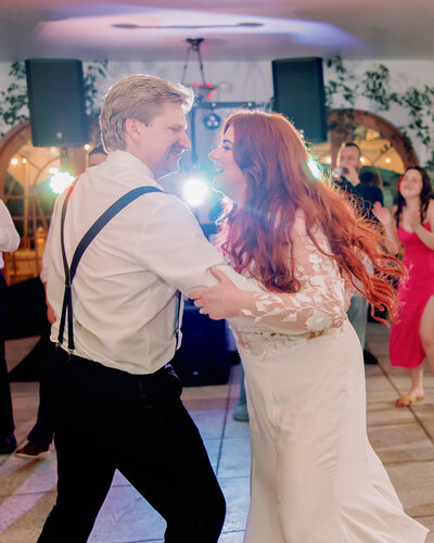 A newlywed couple dancing at their wedding reception 
