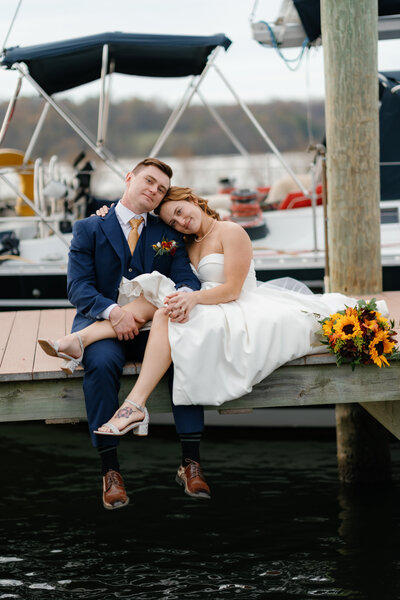 Newlyweds sitting on a dock