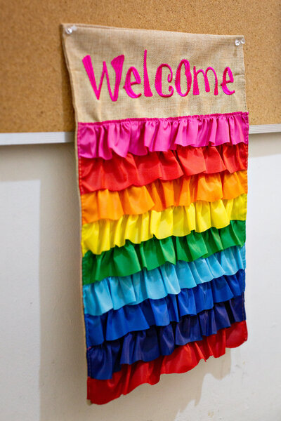 image of a welcome banner with rainbow colored ruffles from the lobby of the pride center