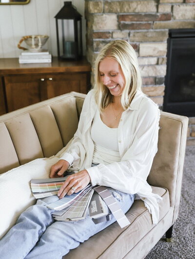 Kaitlyn Schultz reviewing paint swatches and material samples.
