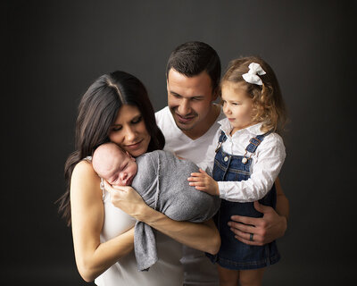 family holding each other picture in studio located in pittsburgh pa for
