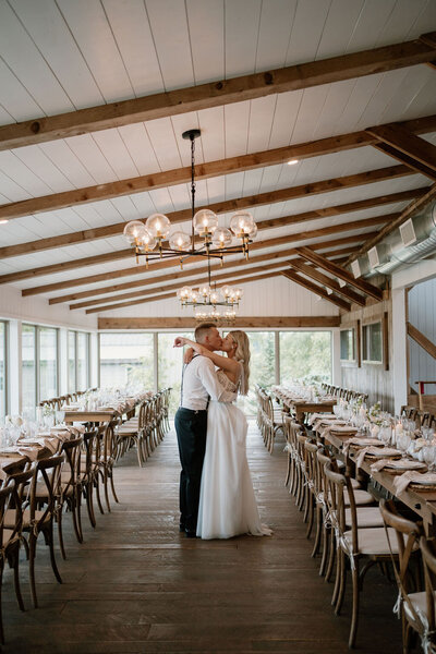 bride and groom standing in the center of the glass enclosed reception space at the Willowbrook wedding venue