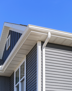 Close-up of gutter and siding installation on home exterior by Black Bear Roofing.