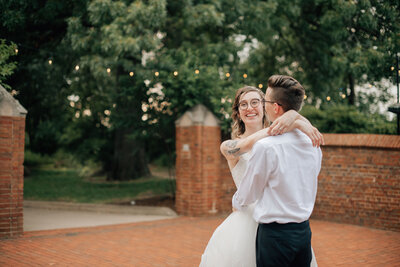 Bride and Groom dance in the courtyard  at Rollins Mansion. Photo by DSM wedding photographer, Anna Brace.