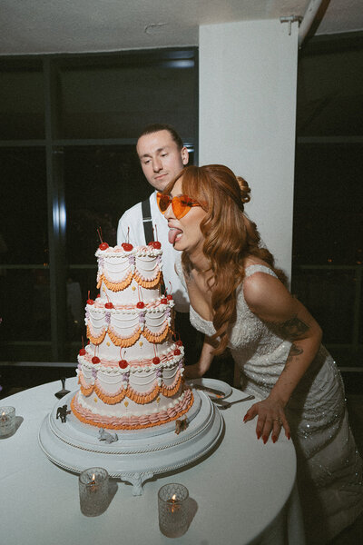 Fun bride and retro wedding cake moment by Pennsylvania wedding photographer