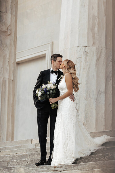 bride and groom posing near spiral staircase in philly for their wedding