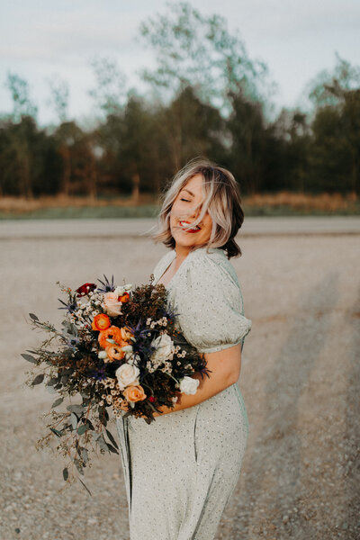 woman smiling and holding flowers